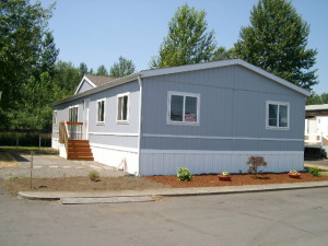 Blue and white manufactured home on lot